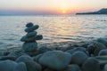 Beautiful sunset at sea and balancing pyramid of stones Royalty Free Stock Photo
