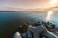 Beautiful sunset seascape. Breakwaters tetrapods ashore of pier. Cargo ships on the horizon. Travel dreams and motivation Royalty Free Stock Photo