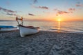 Beautiful sunset at the seashore and the boat on the sands of the beach. The Mediterranean Sea . Beach sunset Royalty Free Stock Photo