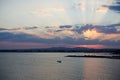 Beautiful sunset on the seaside with residential houses on shore