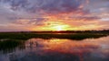 Beautiful sunset setting over water and marshlands in the barrier island creekside waters of the South Carolina coast