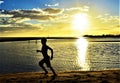 Beautiful sunset and silhouette of child at Hickam Beach, Hawaii