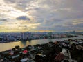 Beautiful sunset sky above the city and river with sky blue and orange light of the sun through the clouds in the sky  Orange and Royalty Free Stock Photo