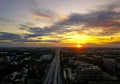 Beautiful sunset sky above the city with sky blue and orange light of the sun through the clouds in the sky. Royalty Free Stock Photo