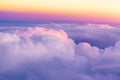 Beautiful sunset sky above clouds with nice dramatic light. View from airplane window