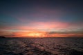Beautiful sunset sky over tropical sea and boat sailing Royalty Free Stock Photo