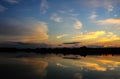 Beautiful sunset. The sunset sky is reflected in the water surface on the lake