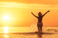 Beautiful sunset and slim girl at the beach Royalty Free Stock Photo