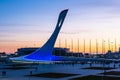 Beautiful sunset in the Sochi Olympic Park. Sculpture of a mythological firebird. People walk waiting for the start of the Olympic