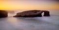 Beautiful sunset and stone arches on Playa de las Catedrales, Spain