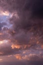Beautiful sunset storm sky. Dark grey pink purple orange violet thunderstorm clouds in sunlight abstract background texture Royalty Free Stock Photo