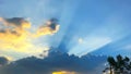 Beautiful sunset sunlight ray and yellow cloudy blue sky in evening Royalty Free Stock Photo