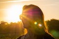 Woman at sunset with sunrays at Campeche beach in Florianopolis Brazil Royalty Free Stock Photo