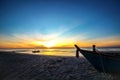 Beautiful sunset sunrise background on the beach with silhouette boat in the foreground