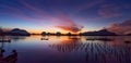 Beautiful sunset or sunrise with dramatic colorful sky clouds over calm sea and reflection in water surface tropical island Royalty Free Stock Photo