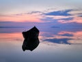 Beautiful sunset/sunrise over water and silhouette fishing boat Royalty Free Stock Photo