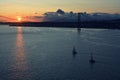 Beautiful sunset. Tejo river. Portugal. April bridge. Lisbon. Almada. Boat boats water sun sky clouds wonderful bright light