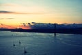 Beautiful sunset. Tejo river. 25th April bridge. Lisbon. Portugal. Almada. Clouds. Yacht. Boat. Sun. Colourfully. Light.