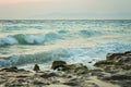 Beautiful sunset to the the roaring Aegean sea in Rhodes, Greece, mountains on the background Royalty Free Stock Photo