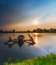 Beautiful sunset and traditional Beautiful little fishing boat with fantastic golden sky and nature Royalty Free Stock Photo