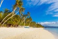 Beautiful sunset on the tropical beach on Boracay island, Philippines. Coconut palm trees, sea, sailboat and white sand. Nature Royalty Free Stock Photo