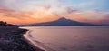 Beautiful sunset twilight on Agnone Bagni sea beach with smoky Etna volcano in far (Siracusa, Sicily, Italy