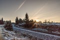 Beautiful sunset view in the background of an old empty railroad covered with snow