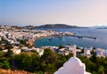 Beautiful sunset view of Mykonos, Cyclades, Greece, rooftop of Greek Orthodox church, bay, ships, cruises, whitewashed Royalty Free Stock Photo