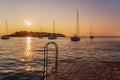 Beautiful sunset views and sailing boats next to the floating swimming platform in the Adriatic sea. Croatia, Porec Royalty Free Stock Photo