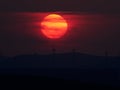 Beautiful sunset with wind turbines on the hill in summer Royalty Free Stock Photo