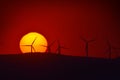 Beautiful sunset with wind turbines silhouettes on the hill Royalty Free Stock Photo