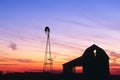 Beautiful sunset of a windmill and barn silhouetted in Indiana Royalty Free Stock Photo