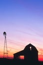 Beautiful sunset of a windmill and barn silhouetted in Indiana Royalty Free Stock Photo