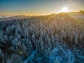 Beautiful sunset in winter behind a frost and snow covered forest on a mountain Royalty Free Stock Photo