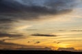 Beautiful sunset with wispy clouds painted in golden colors