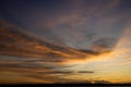 Beautiful sunset with wispy clouds painted in golden colors