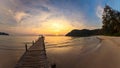 beautiful sunset at the wooden jetty at the beach. Wood bridge on the sea which has walk way for travel with beautiful sky and Royalty Free Stock Photo