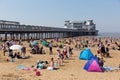Busy UK beach Weston-super-mare with pier on the beautiful May bank holiday weekend