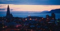 Beautiful super wide-angle aerial view of Reykjavik, Iceland with harbor and skyline mountains and scenery beyond the city, seen f