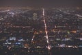 Beautiful super wide-angle night aerial view of Los Angeles, California, USA, with downtown district, mountains and scenery beyond Royalty Free Stock Photo