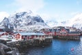 Beautiful super wide-angle winter snowy view of fishing village A, Norway, Lofoten Islands, with skyline, mountains, famous fishin Royalty Free Stock Photo