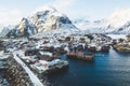 Beautiful super wide-angle winter snowy view of fishing village A, Norway, Lofoten Islands, with skyline, mountains, famous fishin Royalty Free Stock Photo