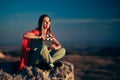 Beautiful Superhero Woman Holding a Cinema Clapper Outdoors