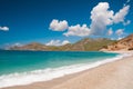 Beautiful surf on the beach. Mountains on the horizon.