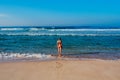 Beautiful surfer girl is enjoying vacation on the tropical beach. Young woman with surfboard in Sri Lanka. Royalty Free Stock Photo