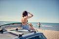 Beautiful surfer girl sitting on the car and getting ready for s Royalty Free Stock Photo