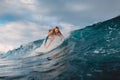 Beautiful surfer girl on surfboard. Woman in ocean during surfing. Surfer and barrel wave