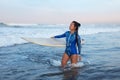 Beautiful Surfer Girl. Surfing Woman With Surfboard Standing In Ocean. Brunette In Blue Wetsuit Waiting Wave. Royalty Free Stock Photo