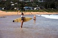 Beautiful surfer woman in bikini waiting for waves