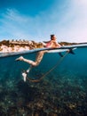 Beautiful surfer woman relax with surfboard. Surfgirl in ocean.